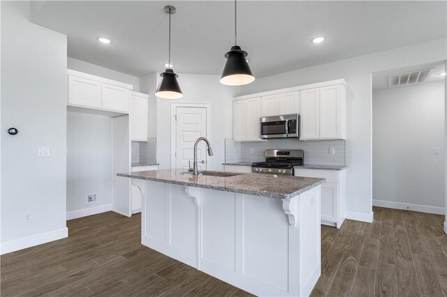 4669 W Triangle St, Fayetteville, AR 72704 - kitchen featuring stainless steel appliances, dark wood finished floors, tasteful backsplash, light stone counters, and recessed lighting