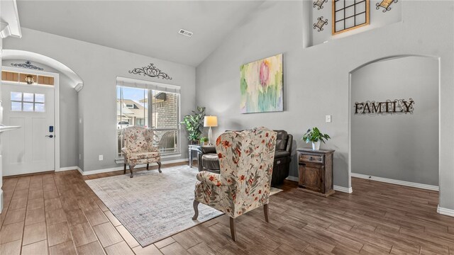 1705 Tull Dr, Pea Ridge, AR 72751 - foyer featuring arched walkways, plenty of natural light, high vaulted ceiling, and wood finished floors