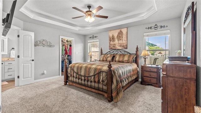 1705 Tull Dr, Pea Ridge, AR 72751 - bedroom with a tray ceiling, light carpet, a walk in closet, a closet, and ceiling fan