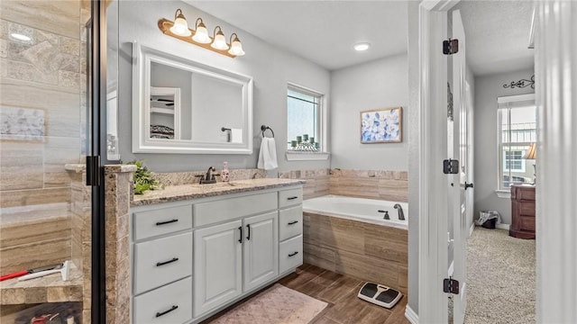 1705 Tull Dr, Pea Ridge, AR 72751 - bathroom with vanity, a garden tub, and a shower stall