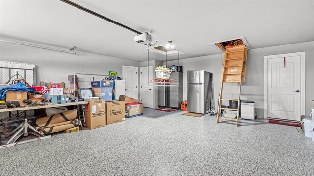 1705 Tull Dr, Pea Ridge, AR 72751 - garage featuring freestanding refrigerator and a garage door opener