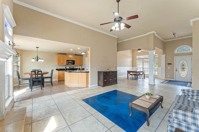 1315 S Breckenridge Loop, Rogers, AR 72756 - living room featuring a ceiling fan, ornamental molding, light tile patterned floors, a high ceiling, and decorative columns