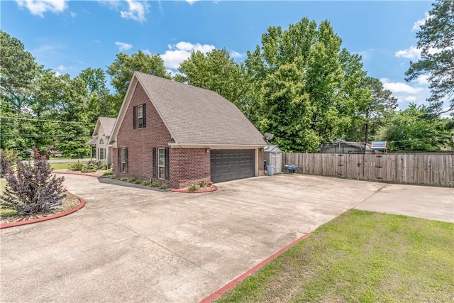3 Jared Ln, Conway, AR 72032 - view of side of property featuring concrete driveway, brick siding, a gate, and roof with shingles