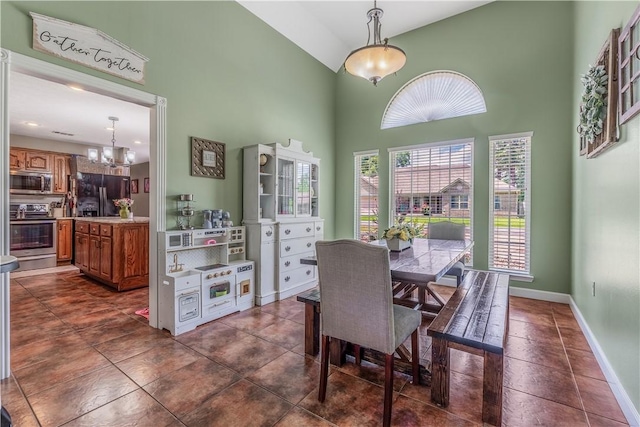 3 Jared Ln, Conway, AR 72032 - dining area featuring high vaulted ceiling, a chandelier, and dark tile patterned flooring