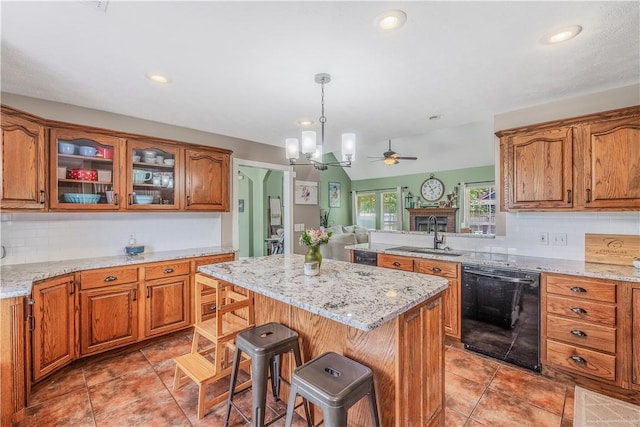3 Jared Ln, Conway, AR 72032 - kitchen with black dishwasher, ceiling fan, brown cabinetry, a breakfast bar, and tasteful backsplash