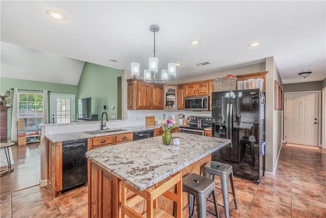 3 Jared Ln, Conway, AR 72032 - kitchen featuring black appliances, brown cabinetry, a peninsula, a chandelier, and light stone countertops