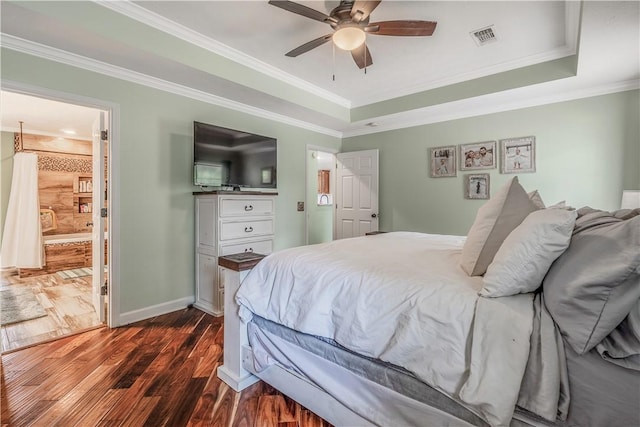 3 Jared Ln, Conway, AR 72032 - bedroom with dark wood-type flooring, a tray ceiling, crown molding, a ceiling fan, and ensuite bathroom