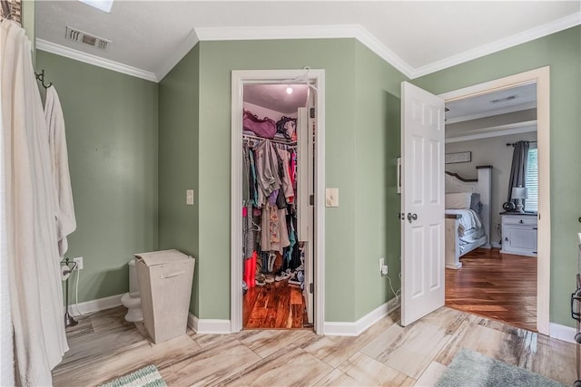 3 Jared Ln, Conway, AR 72032 - bathroom featuring crown molding, ensuite bath, wood finished floors, and a walk in closet