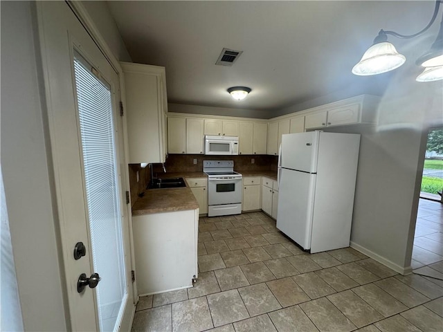 1010 Tori Ln, Beebe, AR 72012 - kitchen with white appliances, light tile patterned floors, white cabinets, and backsplash