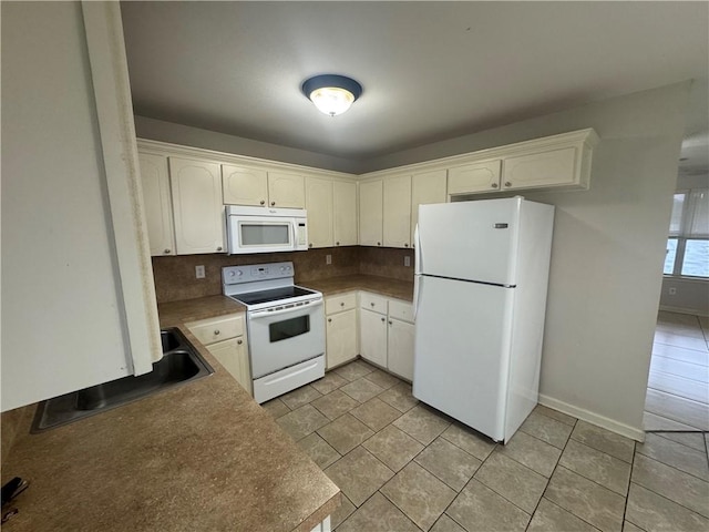 1010 Tori Ln, Beebe, AR 72012 - kitchen with white appliances, backsplash, and white cabinetry