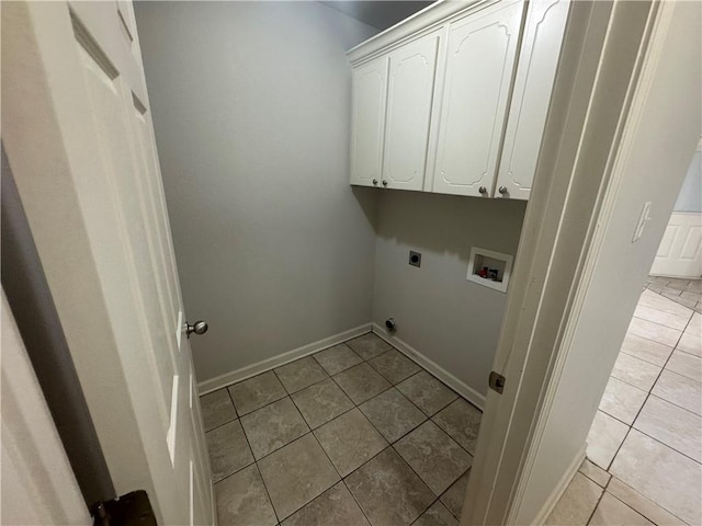 1010 Tori Ln, Beebe, AR 72012 - laundry area featuring electric dryer hookup, washer hookup, cabinet space, and light tile patterned floors