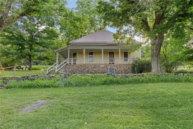 247 NC-3600, Western Grove, AR 72685 - country-style home with a porch, a front lawn, and a metal roof