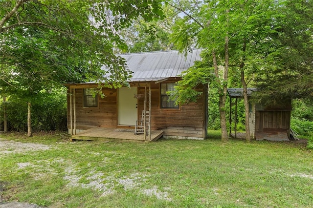 247 NC-3600, Western Grove, AR 72685 - rear view of house featuring a lawn, an outbuilding, and a metal roof