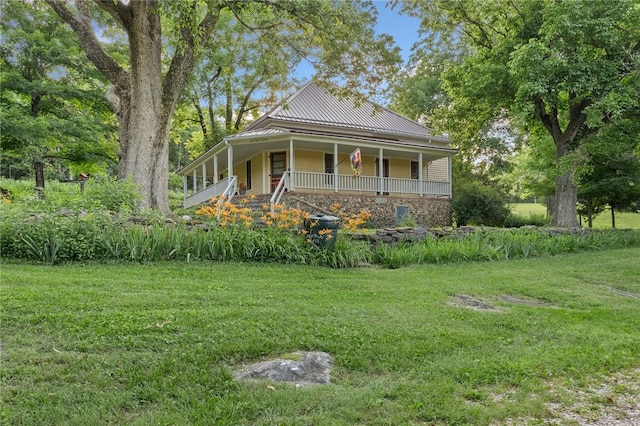 247 NC-3600, Western Grove, AR 72685 - farmhouse-style home with covered porch, a front lawn, and a metal roof