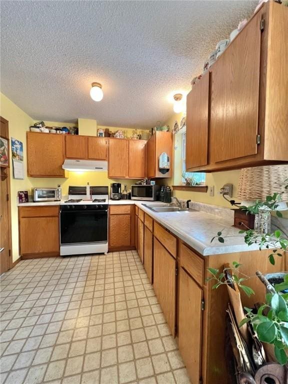 107 Jay Ln, Eureka Springs, AR 72632 - kitchen featuring white gas range oven, under cabinet range hood, stainless steel microwave, light countertops, and a textured ceiling