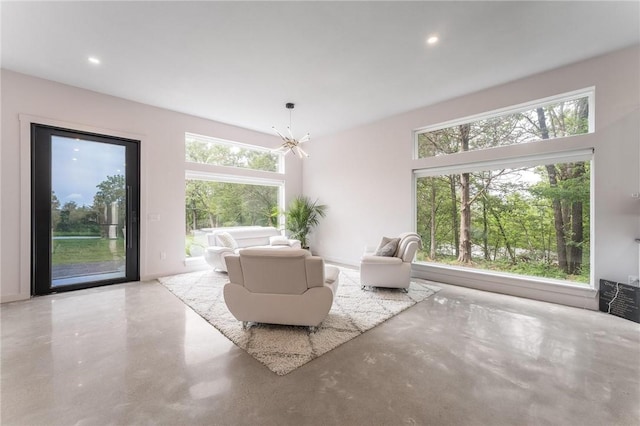 1630 Madison Unit 7855, Huntsville, AR 72740 - living room featuring finished concrete floors, healthy amount of natural light, a chandelier, and recessed lighting