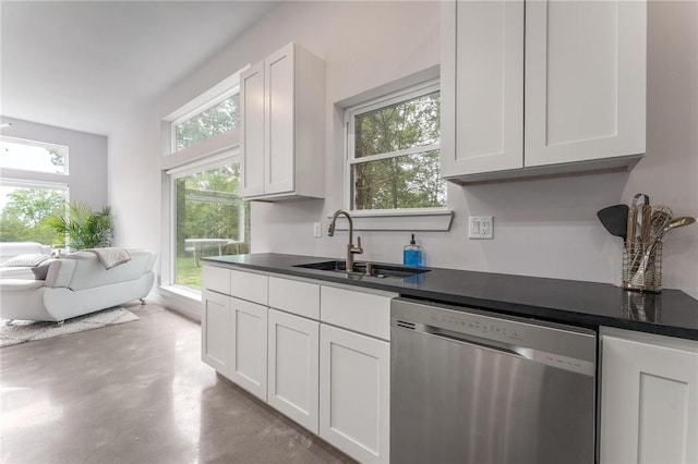 1630 Madison Unit 7855, Huntsville, AR 72740 - kitchen featuring stainless steel dishwasher, finished concrete flooring, dark countertops, and white cabinets