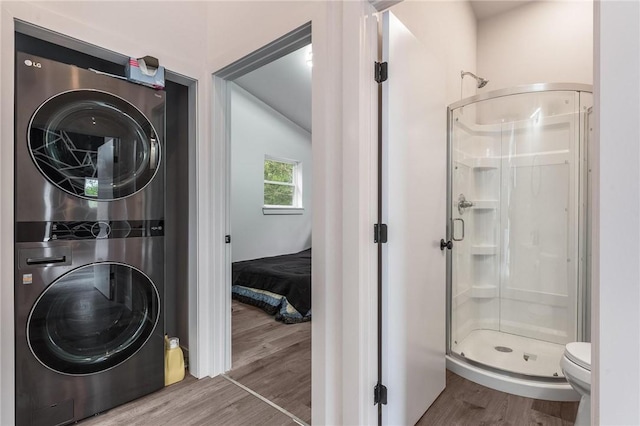 1630 Madison Unit 7855, Huntsville, AR 72740 - full bathroom with stacked washer / dryer, a stall shower, and wood finished floors