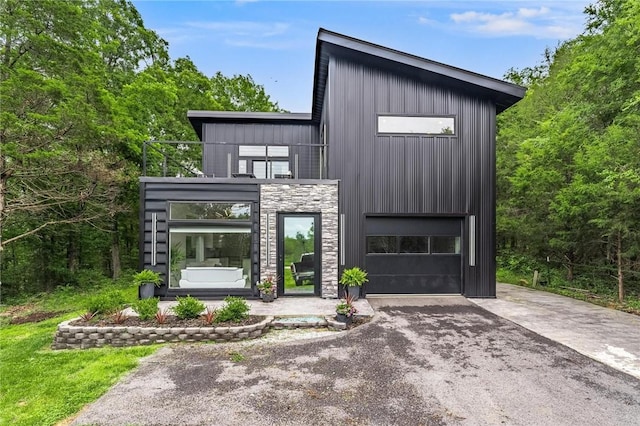 1630 Madison Unit 7855, Huntsville, AR 72740 - contemporary home with asphalt driveway, stone siding, and a garage