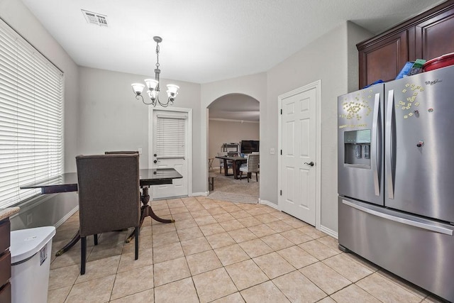 1902 SW Sequoia St, Bentonville, AR 72713 - dining area featuring arched walkways, a chandelier, and light tile patterned floors
