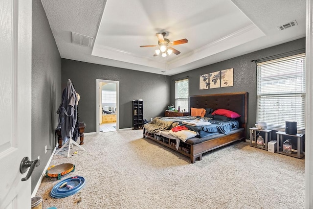 1902 SW Sequoia St, Bentonville, AR 72713 - carpeted bedroom featuring a raised ceiling, ensuite bathroom, crown molding, a textured wall, and ceiling fan