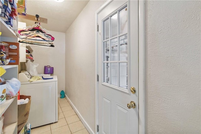 713 Carlton St, Springdale, AR 72762 - laundry room featuring independent washer and dryer, light tile patterned floors, and a textured wall