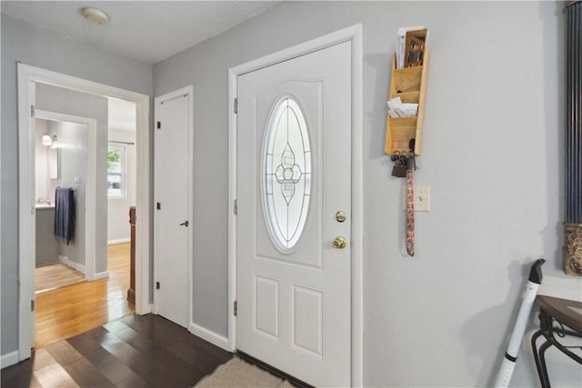 713 Carlton St, Springdale, AR 72762 - entryway featuring dark wood-type flooring and baseboards