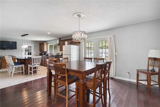 713 Carlton St, Springdale, AR 72762 - dining space with wood finished floors, a textured ceiling, a chandelier, french doors, and recessed lighting