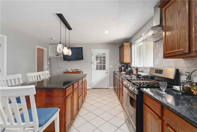 713 Carlton St, Springdale, AR 72762 - kitchen featuring gas stove, wall chimney range hood, light tile patterned floors, backsplash, and a kitchen breakfast bar