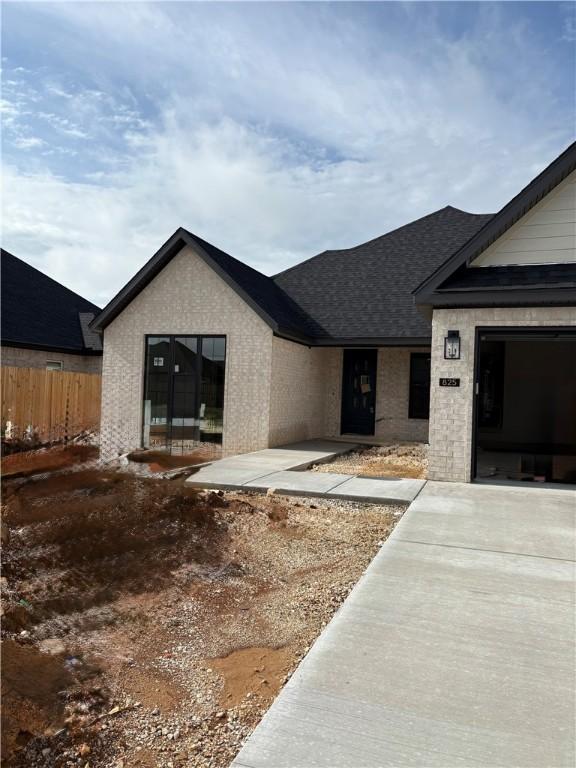 825 Bellagiola, Tontitown, AR 72762 - view of front of property with roof with shingles and brick siding
