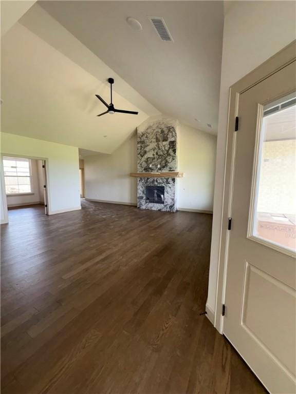 825 Bellagiola, Tontitown, AR 72762 - unfurnished living room featuring vaulted ceiling, ceiling fan, dark wood-style flooring, and a stone fireplace