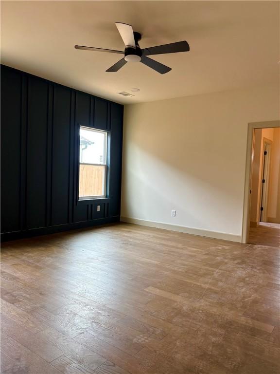 825 Bellagiola, Tontitown, AR 72762 - empty room featuring wood finished floors and ceiling fan