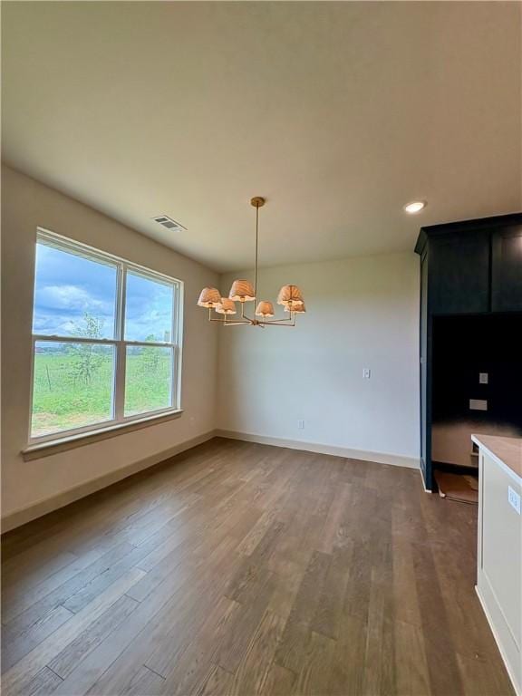 825 Bellagiola, Tontitown, AR 72762 - unfurnished dining area featuring a chandelier, wood finished floors, and recessed lighting