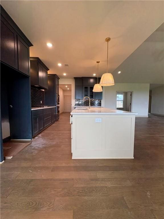 825 Bellagiola, Tontitown, AR 72762 - kitchen featuring light countertops, a center island with sink, decorative backsplash, decorative light fixtures, and recessed lighting
