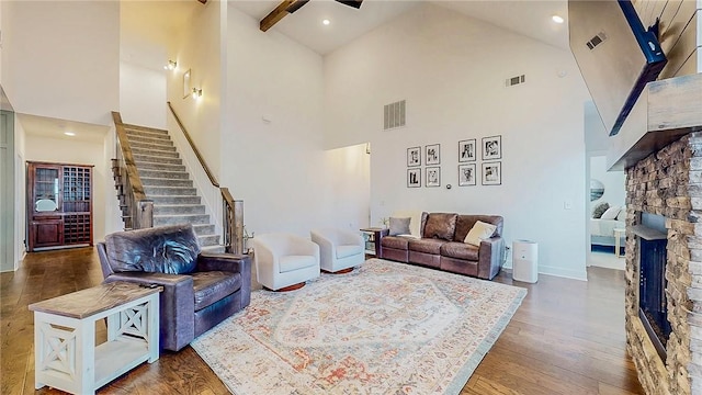 884 Ardiano Ave, Tontitown, AR 72762 - living room with high vaulted ceiling, a fireplace, stairs, wood finished floors, and ceiling fan