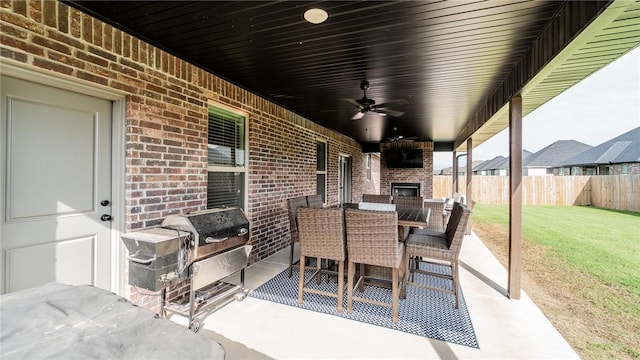 884 Ardiano Ave, Tontitown, AR 72762 - view of patio with an outdoor brick fireplace, area for grilling, outdoor dining area, and a ceiling fan