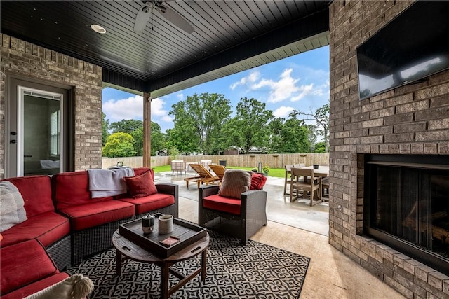320 Bequette Ln, Centerton, AR 72719 - fenced backyard featuring an outdoor living space with a fireplace, outdoor dining area, a patio area, and a ceiling fan