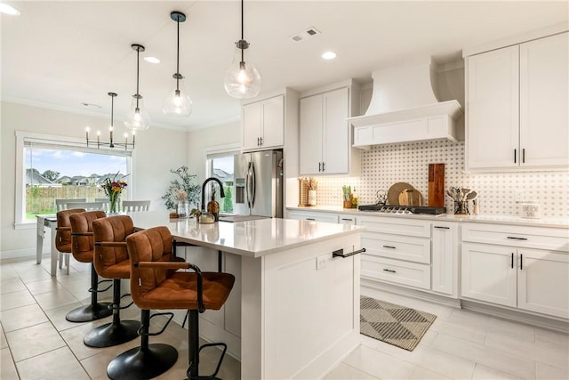 320 Bequette Ln, Centerton, AR 72719 - kitchen with custom range hood, appliances with stainless steel finishes, tasteful backsplash, plenty of natural light, and ornamental molding