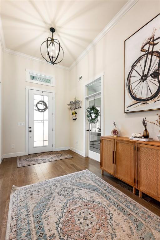 320 Bequette Ln, Centerton, AR 72719 - entrance foyer with a chandelier, wood finished floors, and ornamental molding
