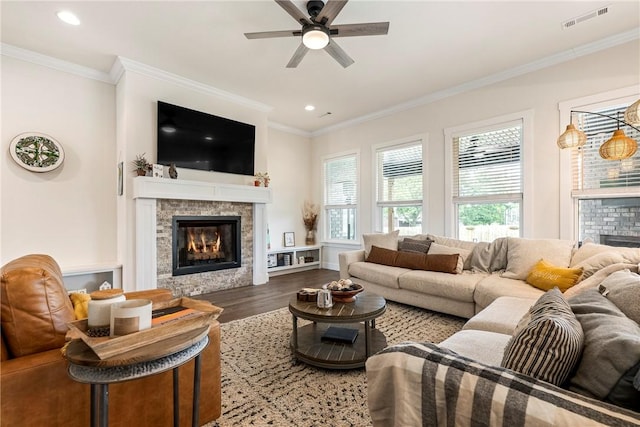 320 Bequette Ln, Centerton, AR 72719 - living room featuring a glass covered fireplace, wood finished floors, ceiling fan, recessed lighting, and crown molding