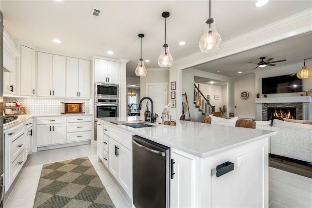 320 Bequette Ln, Centerton, AR 72719 - kitchen featuring appliances with stainless steel finishes, an island with sink, ceiling fan, ornamental molding, and open floor plan