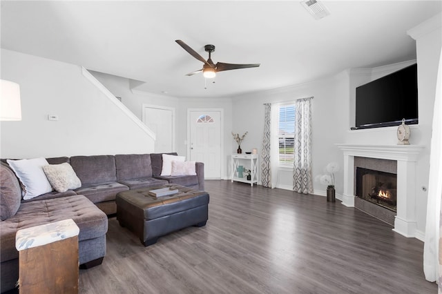 874 Oakwood Ln, Centerton, AR 72719 - living room featuring a ceiling fan, wood finished floors, and a warm lit fireplace