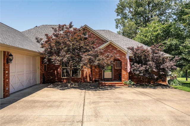 217 Waterfront Cir, Alma, AR 72921 - view of front of home with a shingled roof, brick siding, concrete driveway, and a garage