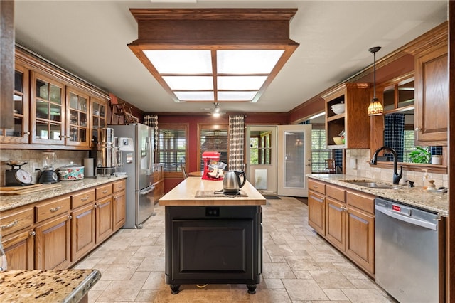 217 Waterfront Cir, Alma, AR 72921 - kitchen with appliances with stainless steel finishes, decorative backsplash, light stone finish floors, a kitchen island, and glass insert cabinets