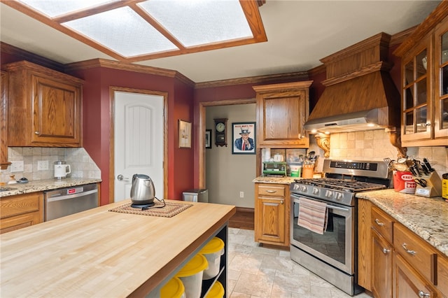 217 Waterfront Cir, Alma, AR 72921 - kitchen with stainless steel appliances, wooden counters, decorative backsplash, glass insert cabinets, and crown molding