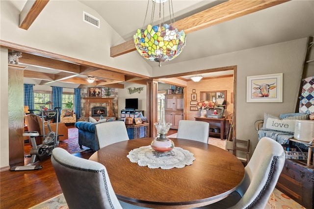 217 Waterfront Cir, Alma, AR 72921 - dining area featuring wood finished floors, a lit fireplace, ceiling fan, and ornate columns