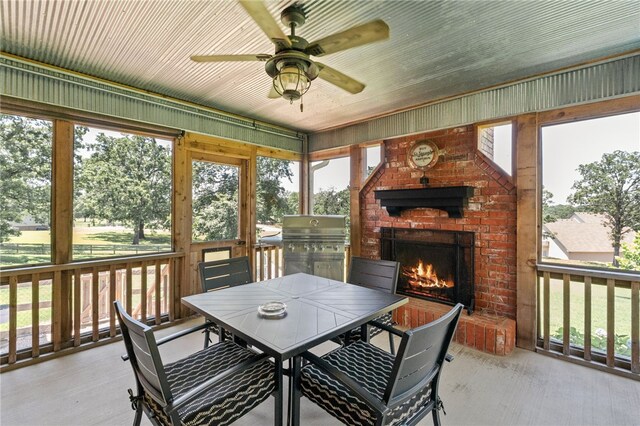 217 Waterfront Cir, Alma, AR 72921 - sunroom featuring a fireplace, ceiling fan, and outdoor dining area