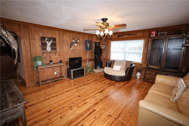 4639 Quail Ct, Harrison, AR 72601 - living room featuring ceiling fan, light wood finished floors, and wooden walls