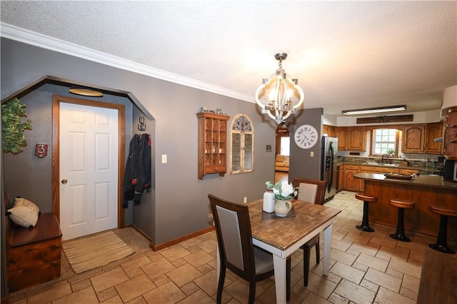 4639 Quail Ct, Harrison, AR 72601 - dining space with a chandelier, stone tile flooring, and crown molding
