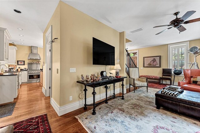 32 Armstrong St, Eureka Springs, AR 72632 - living area with light wood-type flooring, ceiling fan, stairs, and recessed lighting